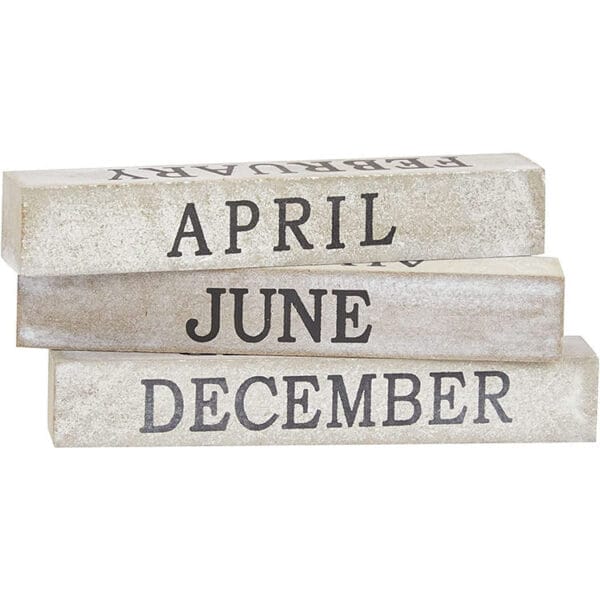 Stack of wooden blocks spelling out APRIL, JUNE, and DECEMBER. Eco-friendly calendar blocks for wholesale.