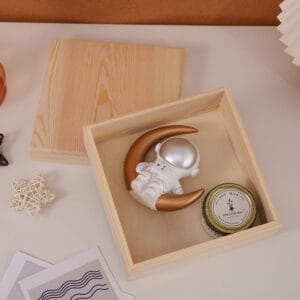 Custom Wooden Keepsake Box: Handmade wooden box with lift-off lid, perfect for storing small gifts or treasures. Features an astronaut figurine and soy candle.