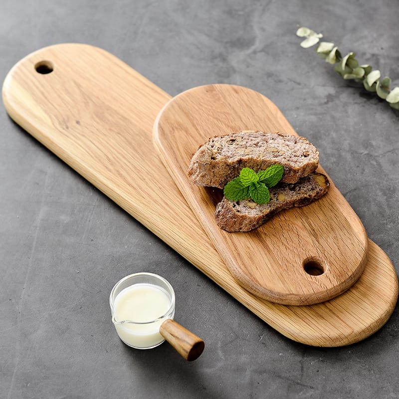 Two oval wooden bread boards, perfect for serving steak or bread. A cutting board supplier's high-quality product.