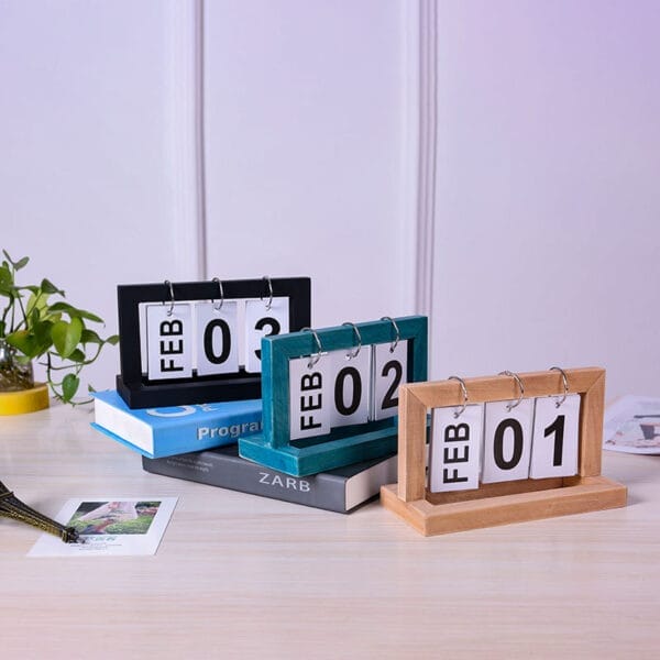 Three wooden perpetual calendars showing February 1st, 2nd, and 3rd. Eco-friendly flip calendars.