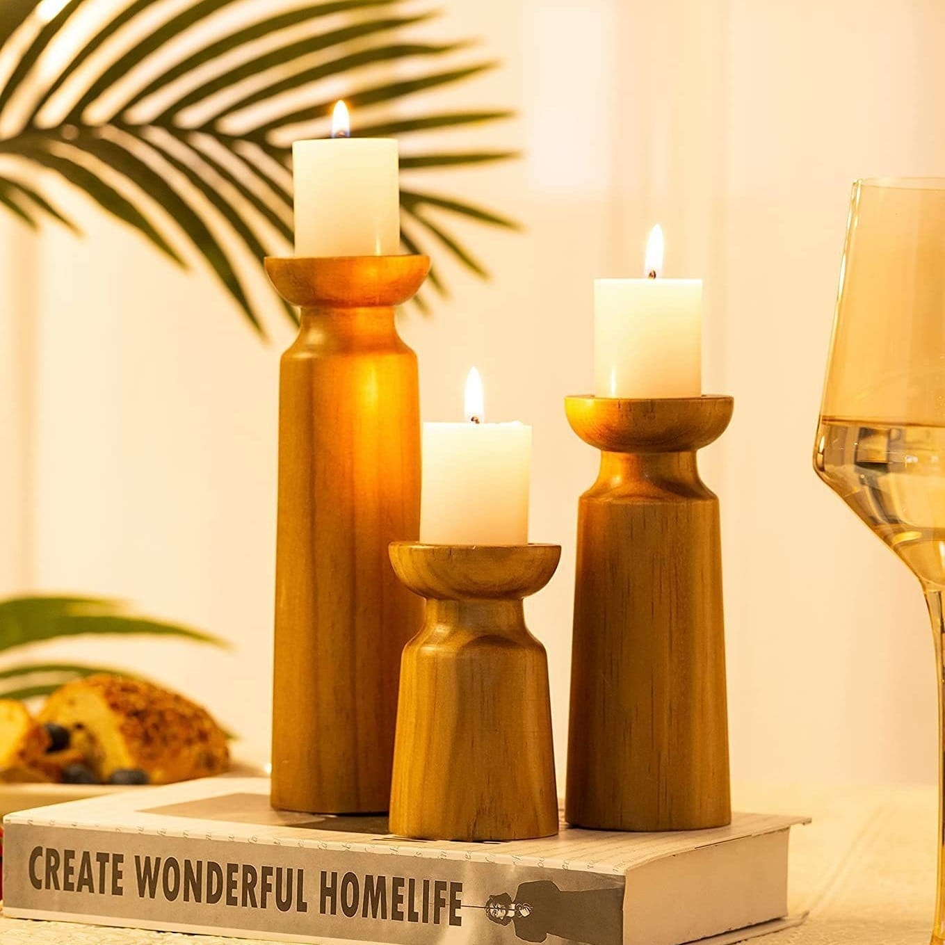 Three wooden candle holders with lit candles. Perfect for wholesale.