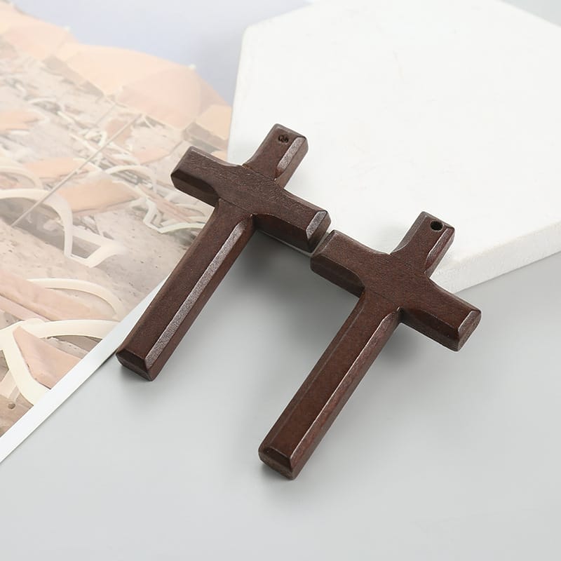 Dark brown wooden crucifix pendants, perfect for men's religious jewelry. Customizable wooden cross necklaces.