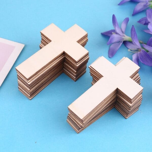 Stacks of unfinished wooden cross cutouts. Eco-friendly craft supplies.