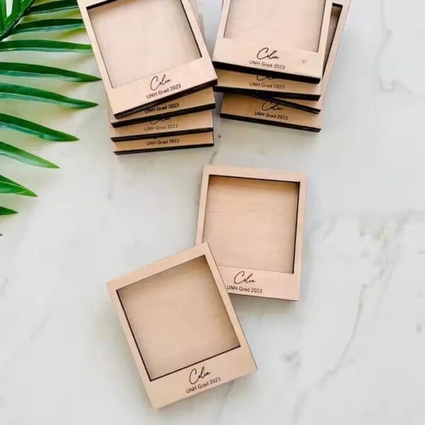 Stack of wholesale wooden mini photo frames, personalized with "Colin UNH Grad 2023
