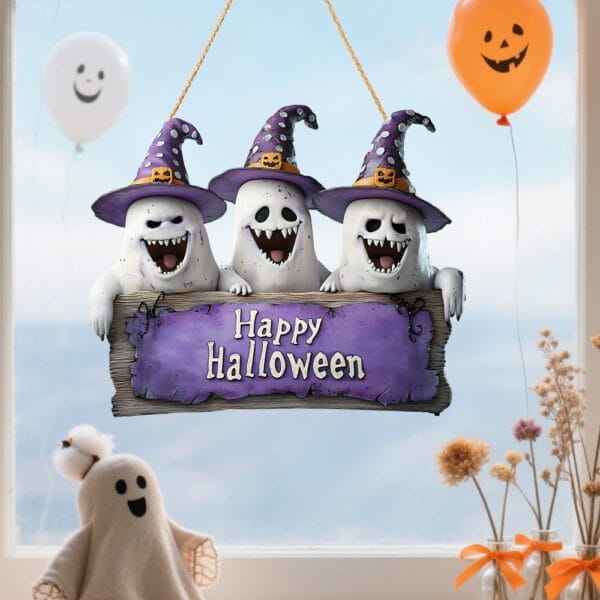 Three cute ghosts in witch hats hang from a wooden "Happy Halloween" sign. Halloween decoration.