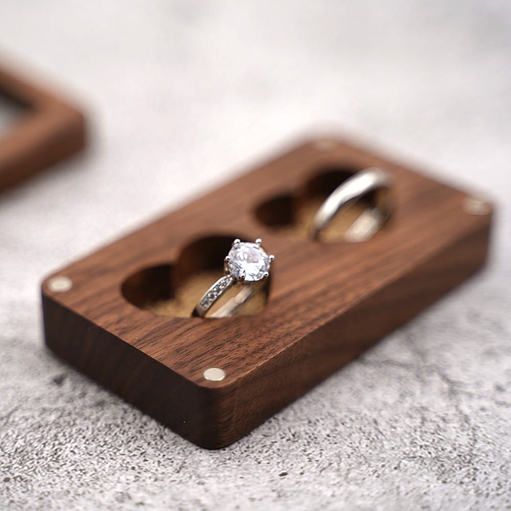 Walnut wooden ring box with two rings, perfect for engagement or wedding rings. A beautiful jewelry holder.