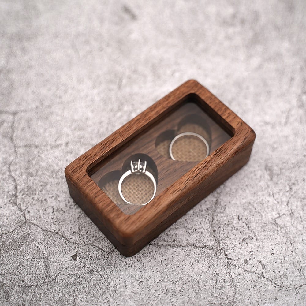 Rustic wooden ring box with heart-shaped compartments, perfect for wedding or engagement rings.