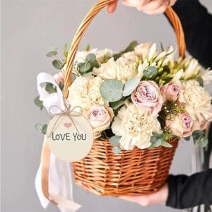 Wooden basket of flowers with a "Love You" tag.