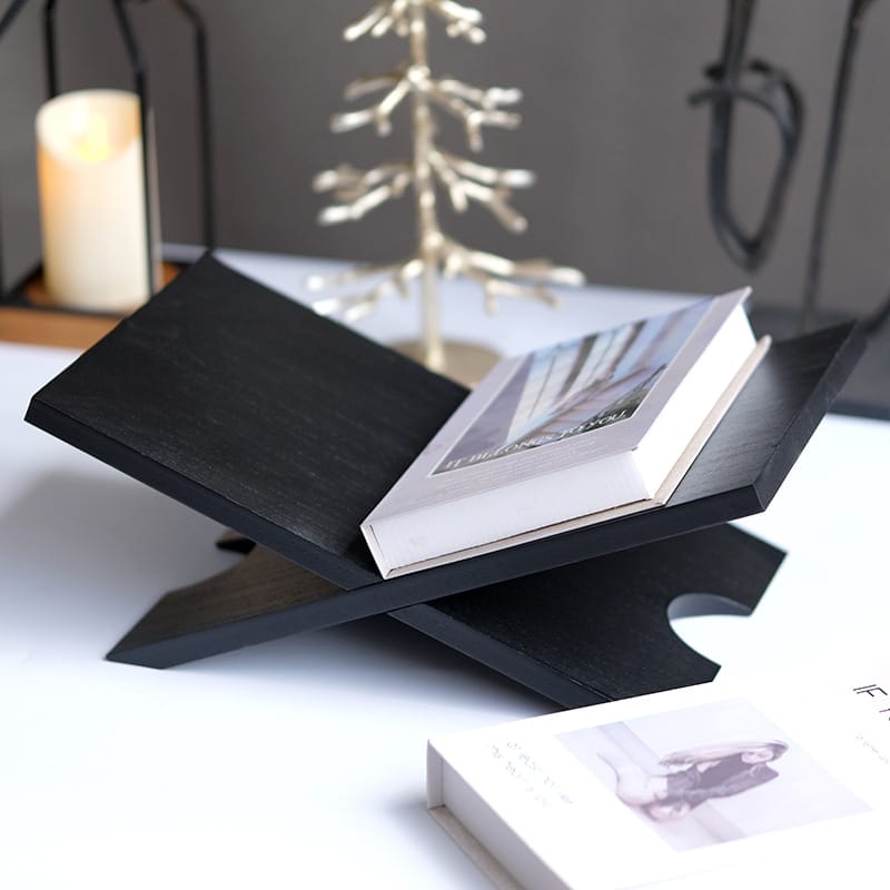 Black wooden X-shaped book stand, perfect for displaying books and magazines. A stylish wood reading rack and display stand.