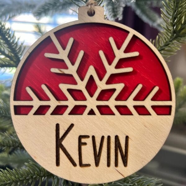 Personalized wooden Christmas ornament with snowflake design and name "Kevin".