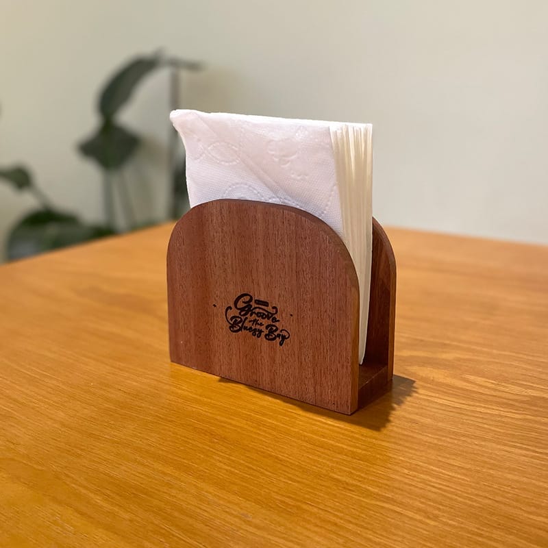Wooden napkin holder for restaurants, crafted from wood. Features a vertical design for tabletops.