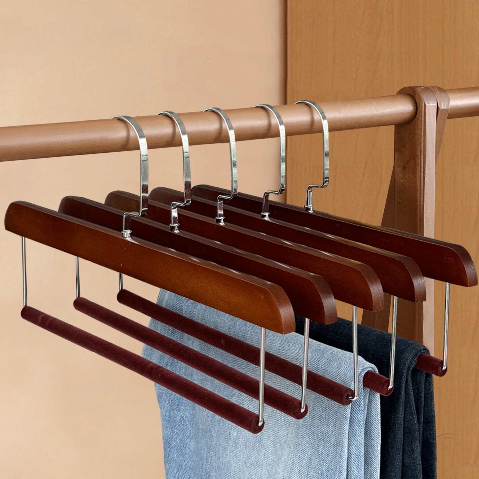 Space-saving wooden pant hangers: Set of four brown wooden hangers with velvet-covered bars, ideal for closet organization.