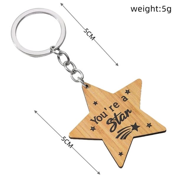 Personalized wooden keychain with a five-pointed star charm engraved with "You're a Star