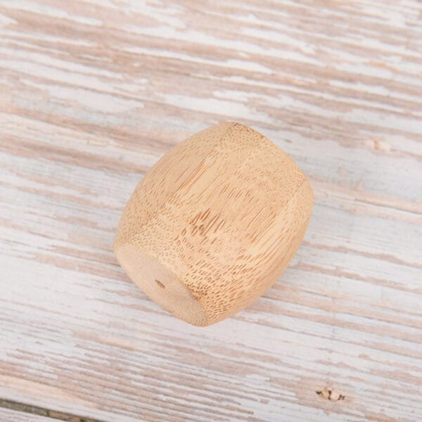 Bamboo toothbrush holder: Eco-friendly wooden stand for hotel bathrooms. Durable bamboo construction.