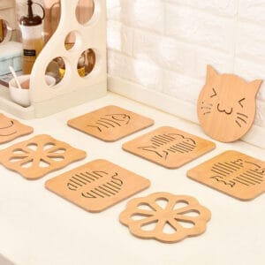 Set of eight cute, wooden coasters with various cut-out designs, including cats and flowers.