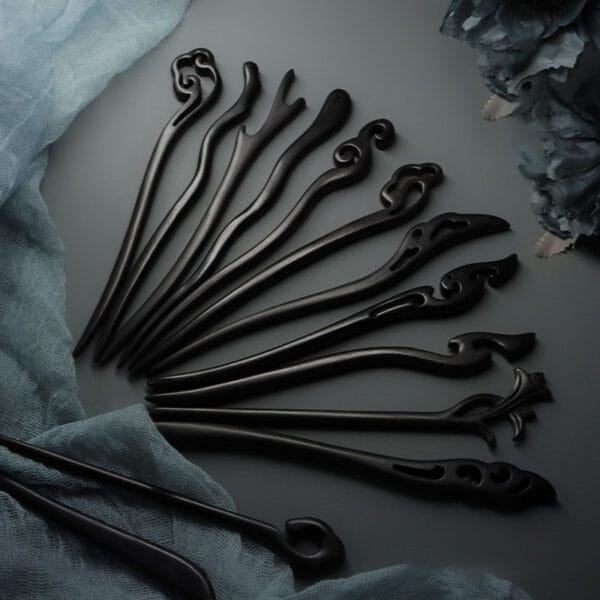 Elegant black wooden hair sticks, intricately carved with unique designs. Perfect for adding a touch of style to any hairstyle.
