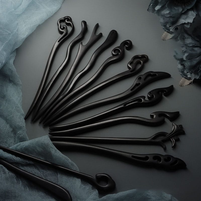 Elegant black wooden hair sticks, intricately carved with unique designs. Perfect for adding a touch of style to any hairstyle.