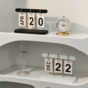 Black and white perpetual desk calendars showing April 20 and December 22, with a small clock.