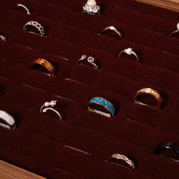 Custom Burl Wood Jewelry Box: A laser-cut burl wood jewelry box filled with various rings, perfect for wholesale.