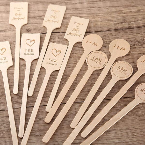 Biodegradable wooden coffee stirrers with custom logos & dates; perfect wedding favors or event supplies.