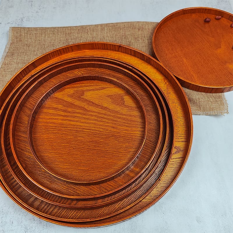 Set of nesting round wooden trays; perfect for serving fruit or other items. Made of light brown wood.