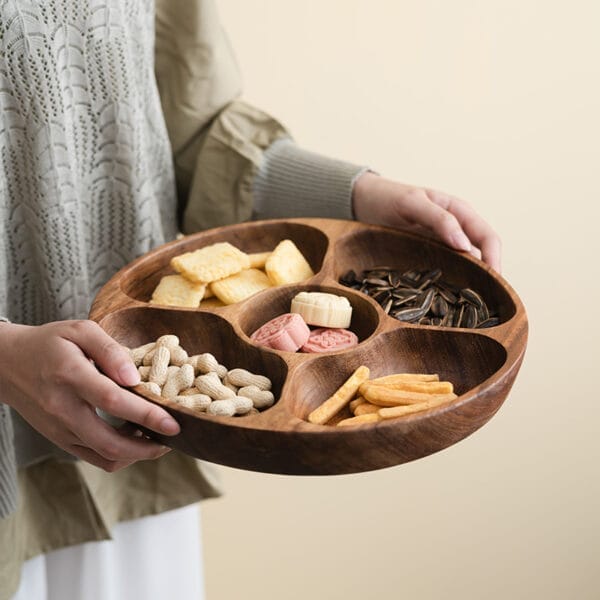 Wooden snack bowl with five compartments, perfect for serving appetizers or snacks. Features peanuts, crackers, sunflower seeds, and more.