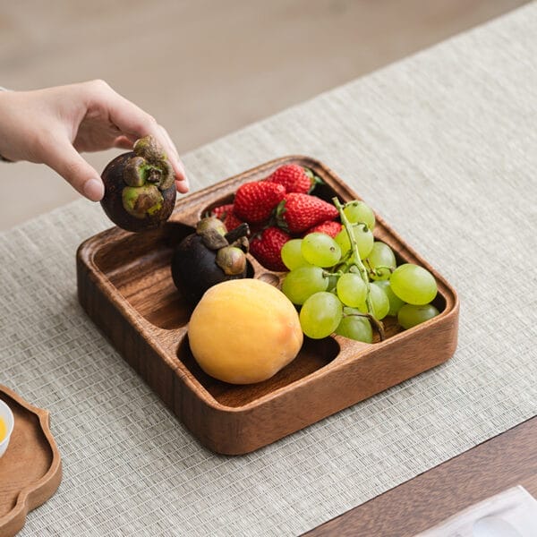 Wooden fruit bowl with divided compartments, perfect for serving snacks or fruit. Features mangosteens, strawberries, grapes & peach.