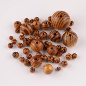 Assortment of brown wooden beads of varying sizes, perfect for jewelry making.