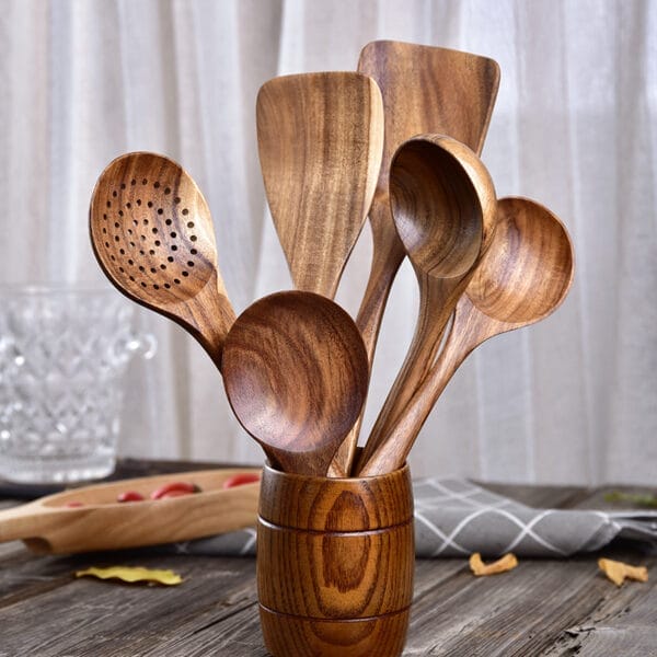 Set of custom teak wood cooking spoons and utensils in a wooden holder. Wholesale kitchenware.