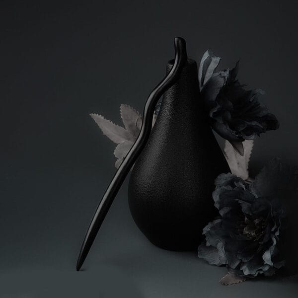 Elegant black wooden hair stick, handcrafted and perfect for adding a touch of sophistication to any hairstyle.