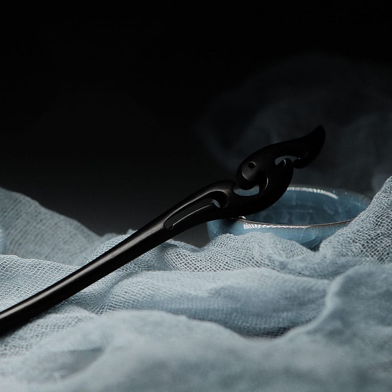 Intricate black wooden hair stick, elegant hair accessory. Wholesale custom options available.