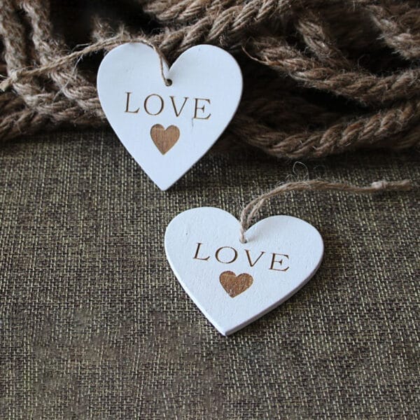 Custom Wooden Hearts for crafts: Two white, laser-cut "LOVE" hearts, perfect for wedding crafts or DIY projects. Wholesale available.