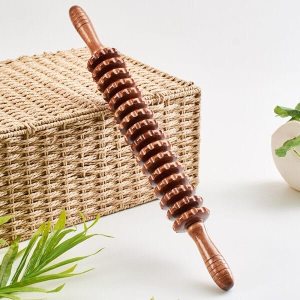 Wooden massage roller with cog-like indentations for self-massage. Perfect for back, muscle, and pain relief.