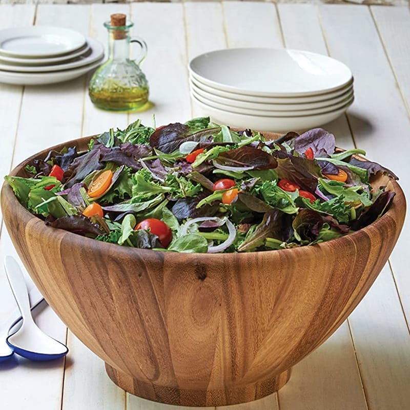Large acacia wooden salad bowls wholesale filled with mixed greens, cherry tomatoes, and red onion. Perfect for serving large salads.