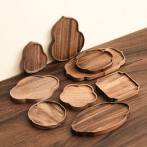Assortment of handcrafted wooden coasters and trays in various shapes.