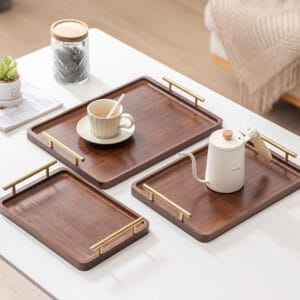 Three wooden serving trays with gold handles, holding coffee cup and pour-over kettle.