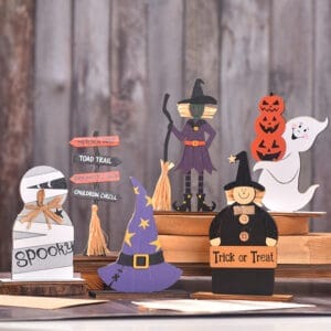 Cute Halloween wooden figurines: witch, ghost, mummy, and pumpkin. Trick or Treat sign.