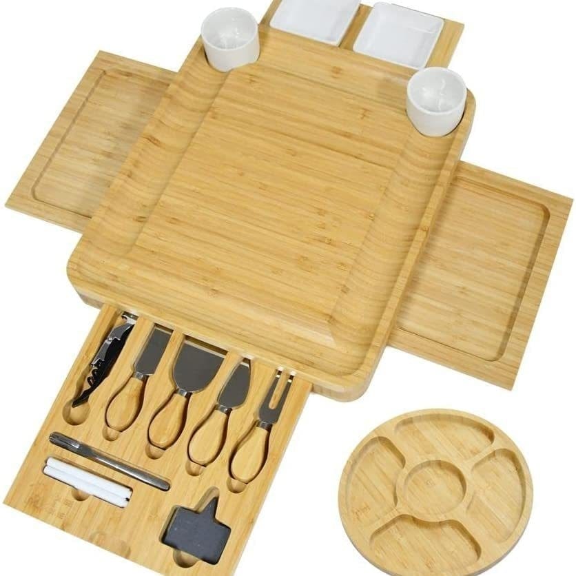 Bamboo cheese board with built-in drawer for cheese knives, plus additional serving trays. Perfect for charcuterie.