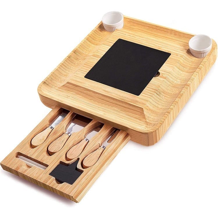 Bamboo cheese board with built-in drawer containing cheese knives and a slate serving area. Perfect for cheese and charcuterie.