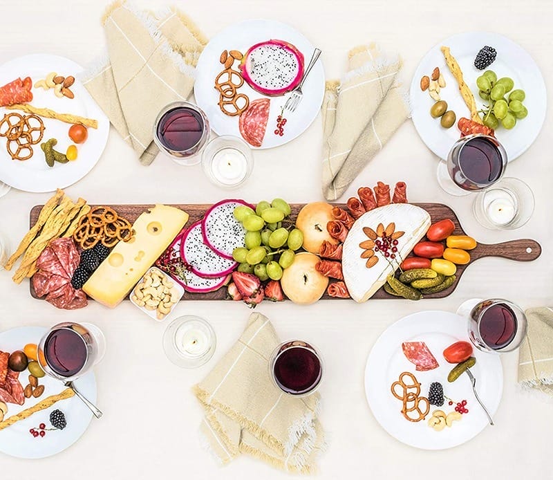 Large walnut charcuterie board with handle, perfect for serving cheese, fruit, bread, and more. Wholesale available.