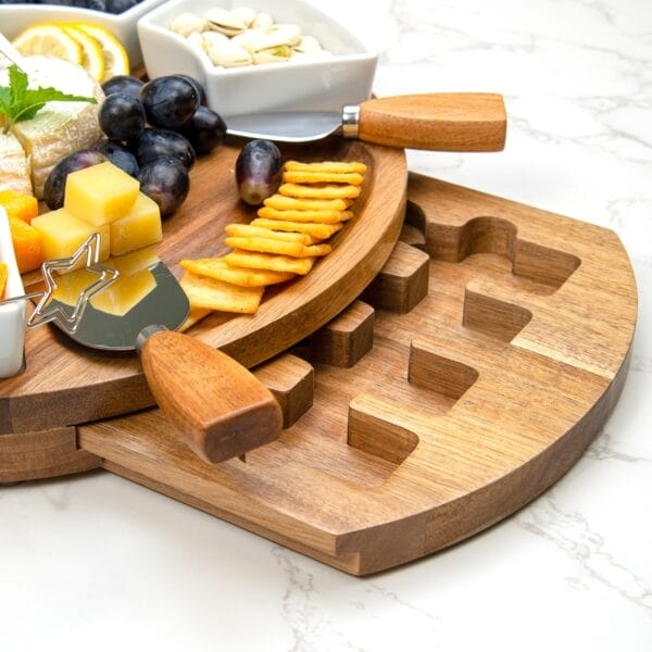Wooden charcuterie board with compartments for cheese, crackers, grapes, and nuts; perfect for entertaining.