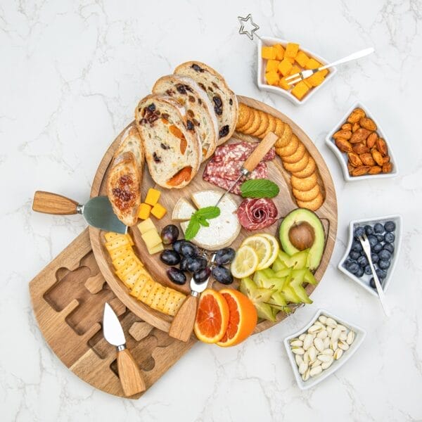 Wooden charcuterie board: A beautifully arranged cheese and appetizer board featuring various cheeses, fruits, crackers, nuts, and meats, perfect for entertaining.