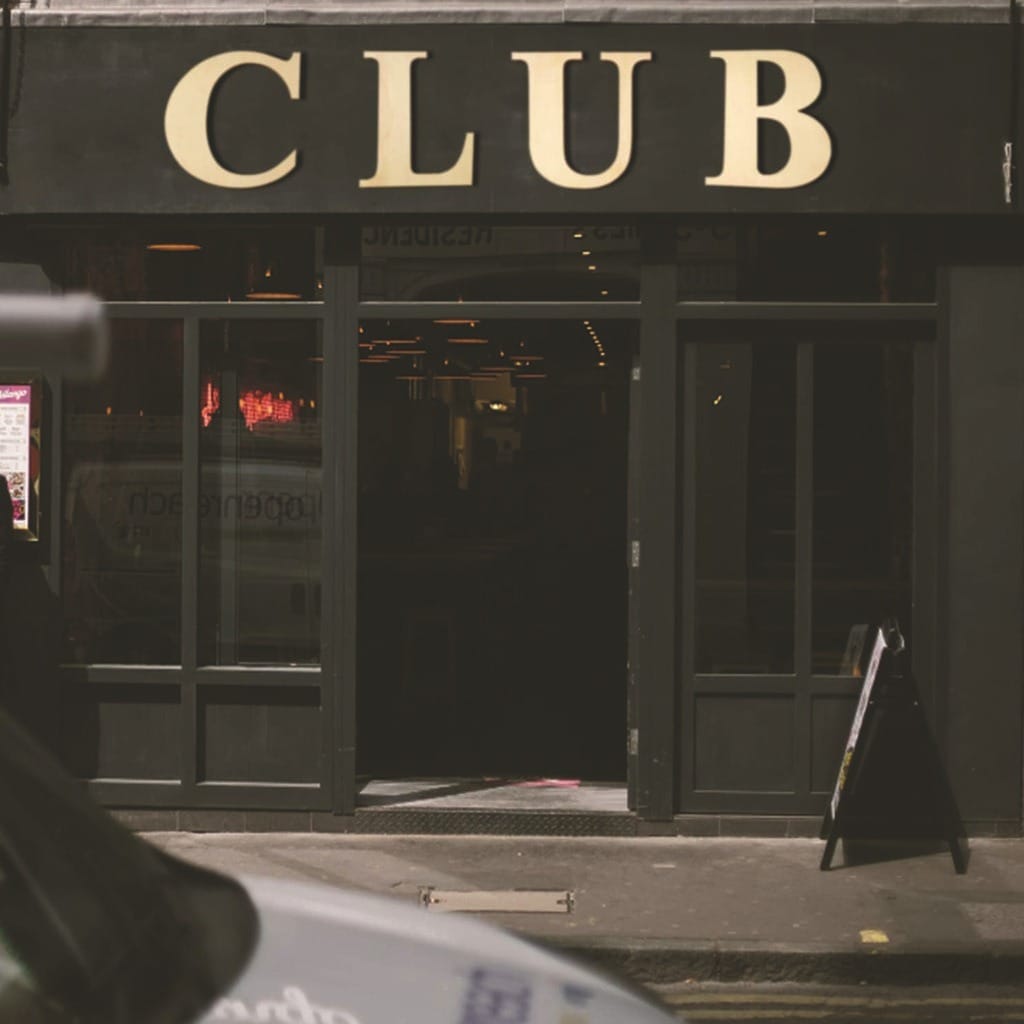Club Entrance: Dark black doorway with "CLUB" sign, inviting patrons to a nightclub, bar, or entertainment venue for nightlife.