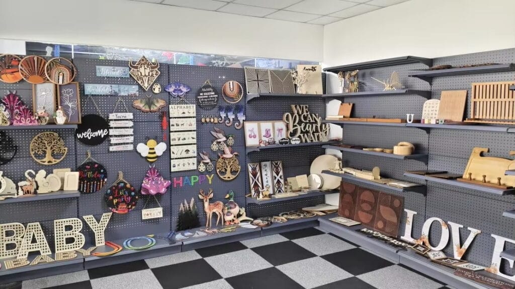 Craft store display featuring wooden art, signs like "Welcome" and "Happy," and decorative letters spelling "Baby" and "Love.