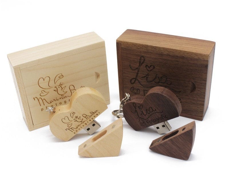 Custom Wooden USB Flash Drives for Wedding Favors: Heart-shaped USBs with engraved logos and matching wooden boxes.