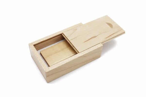 AUTO-DRAFT: Wooden box with sliding lid, partially open, containing a USB drive inside