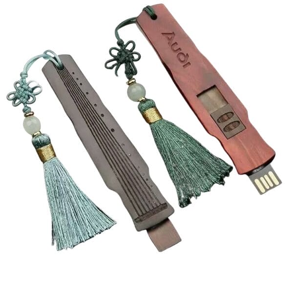 Personalized Wood USB Drives: Custom wooden flash drives with decorative tassels, one engraved with "Audi".