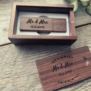 Engraved wood USB drives with "Mr & Mrs" and date, presented in a matching wooden box.