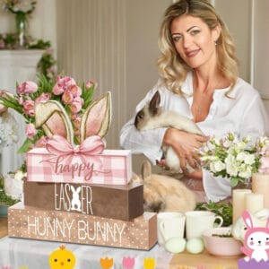Woman holding bunnies with Easter decorations: blocks spelling "Happy Easter Hunny Bunny", flowers, and Easter eggs.