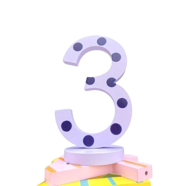 Wooden number 3 with purple polka dots on a pastel base, perfect for kids' learning